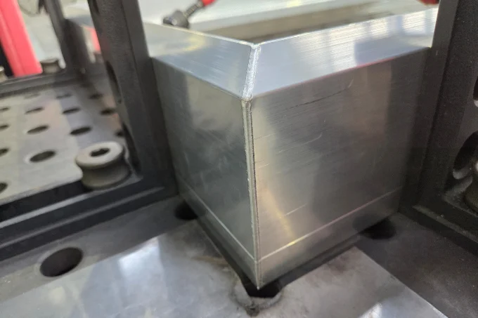Clean corner weld produced with cobot laser welding, showing a smooth finish and minimal distortion.